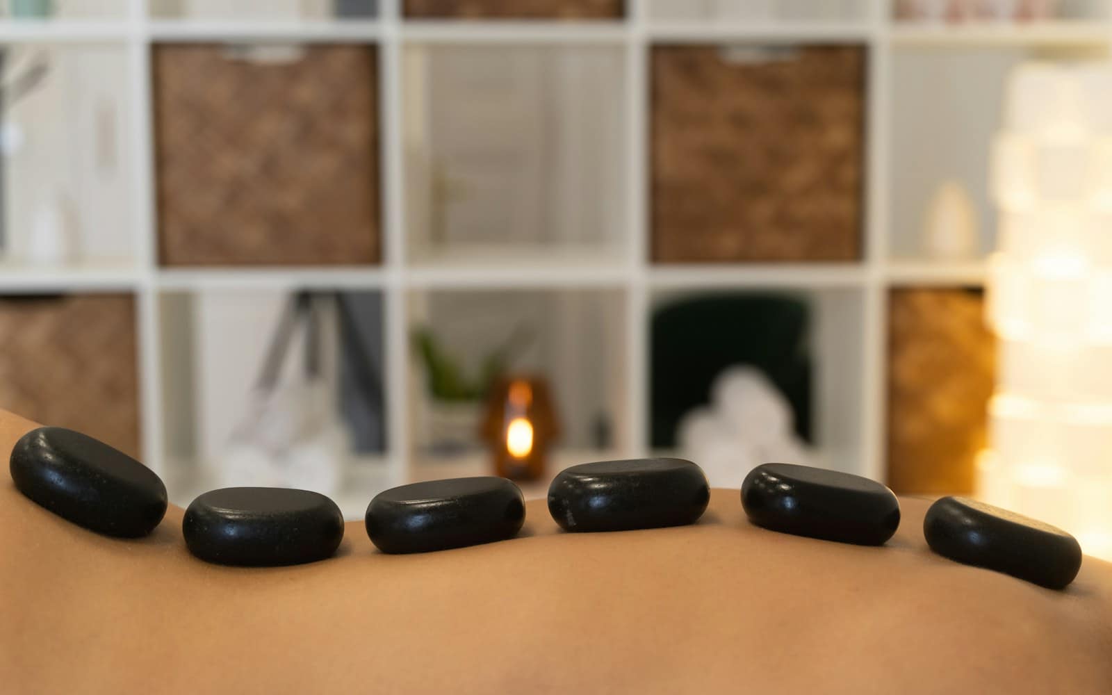A warming stone massage on the back to ease muscle tension