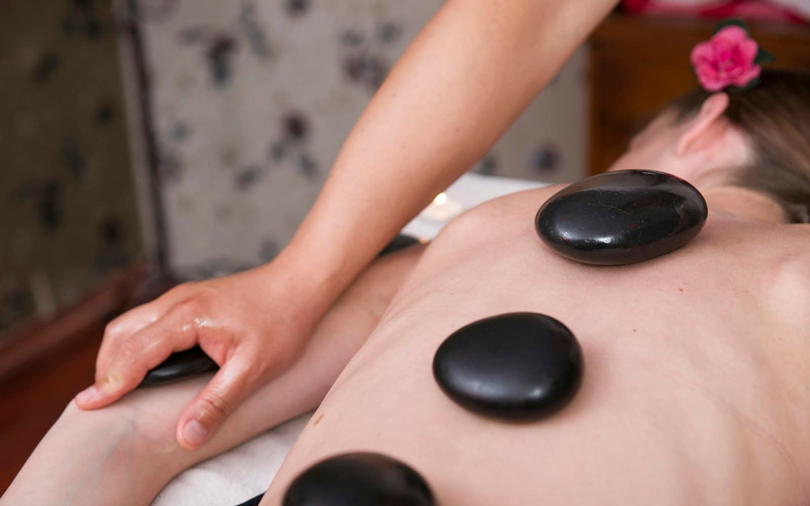 Hot stone massage during a home spa session in Dubai Hot stone massage during a home spa session in Dubai