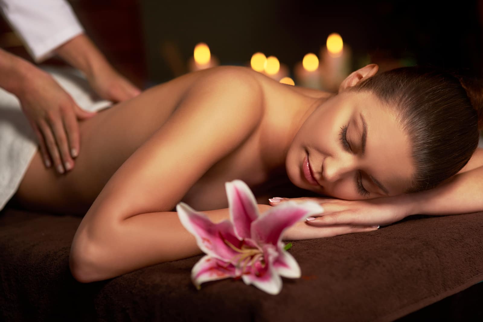 Woman enjoying a professional home massage session in Dubai